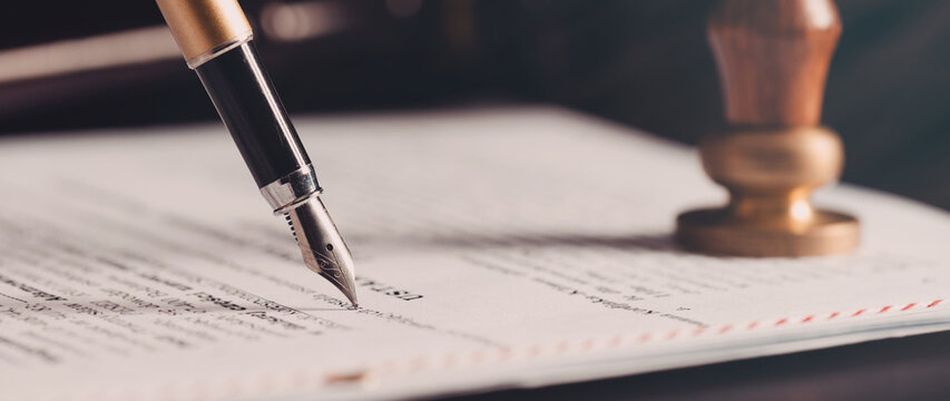 Fountain pen writing on legal documents with notary stamp